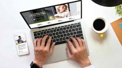 Modern workspace with laptop and smartphone showcasing online business solutions for artists and creatives.